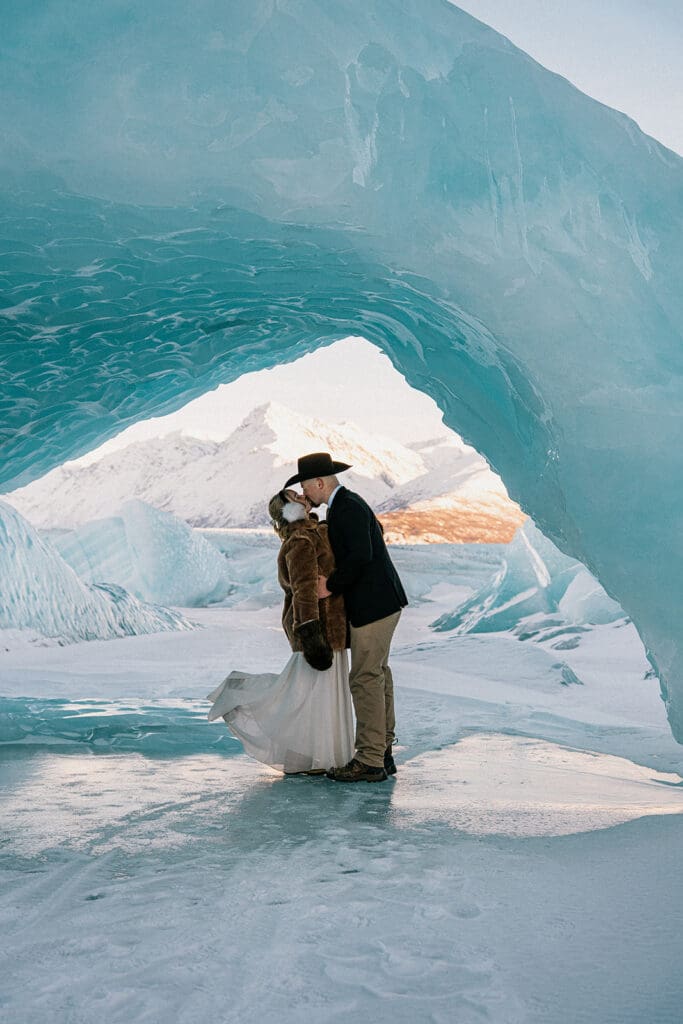 Couple eloping on knik glacier under ice arch