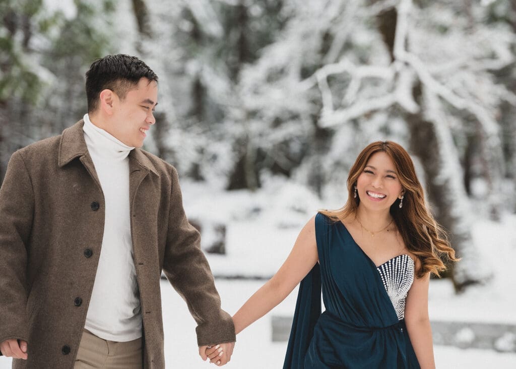 couple walking through Yosemite Valley snow engagement session natural moments