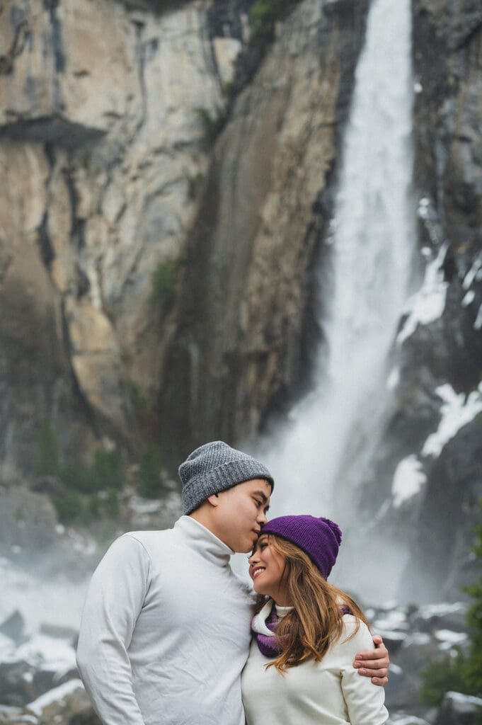 winter Yosemite waterfall engagement session couple in snow-covered valley