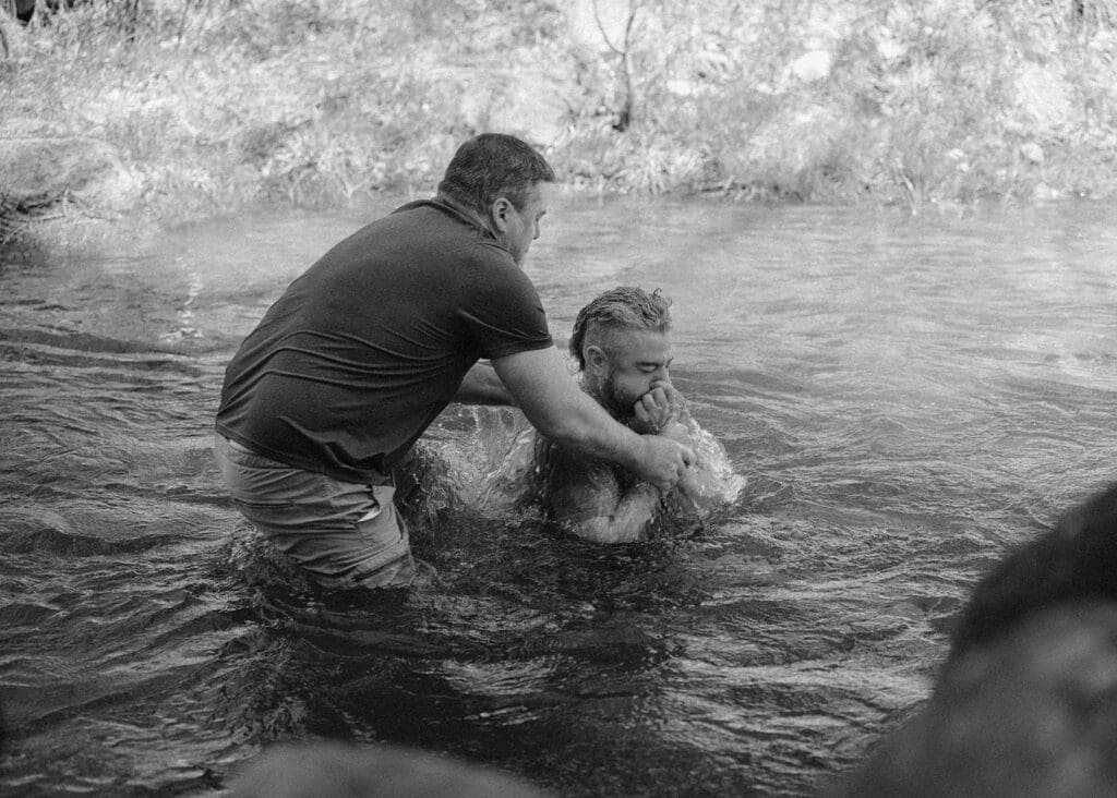 man being baptized week of elopement