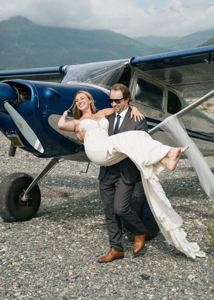 Bride and groom with a bush plane during their adventurous Alaska elopement