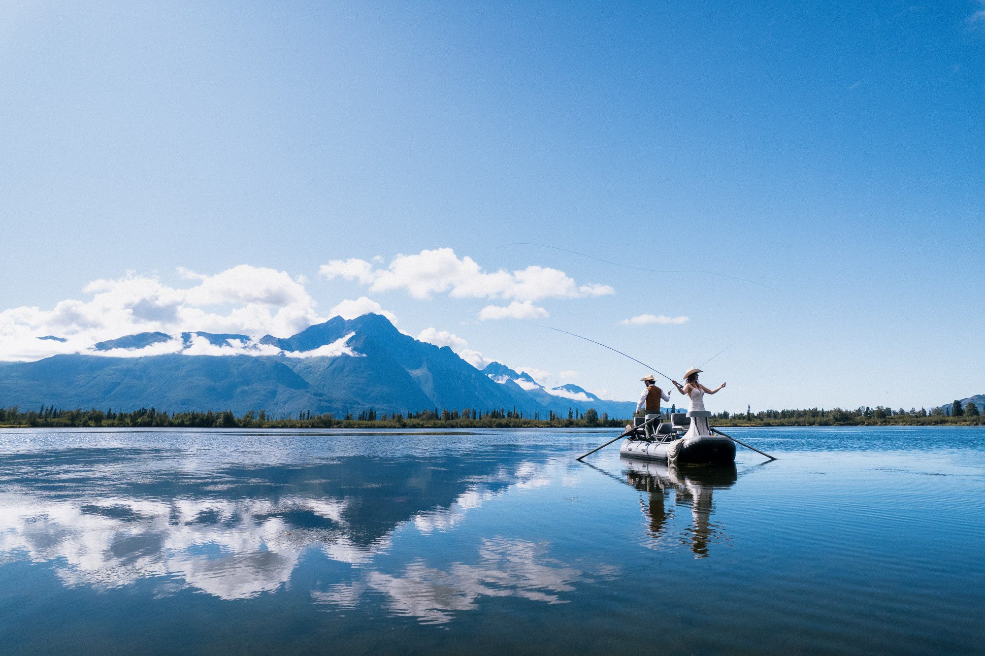 Couple fly fishing during elopement on Jim lake in Alaska