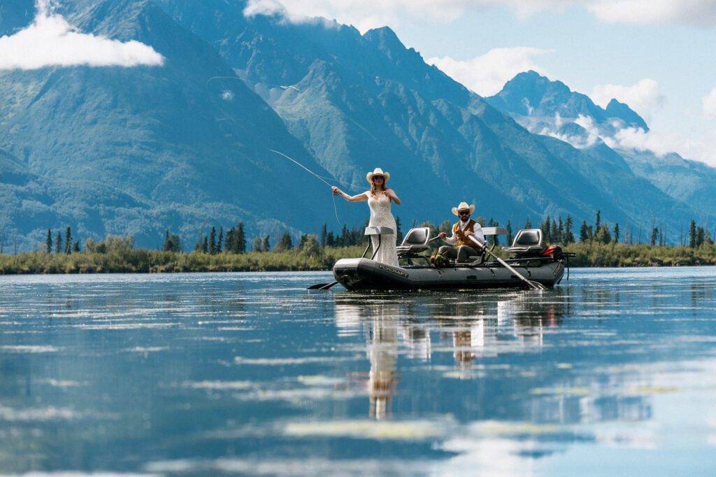Bride and groom fishing together during their Alaska elopement