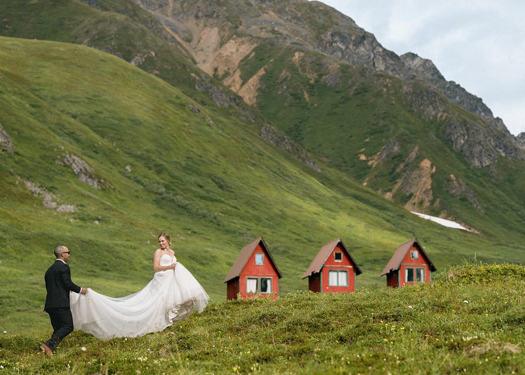 Bride and groom walking through the mountains at Hatcher Pass during an Alaska elopement