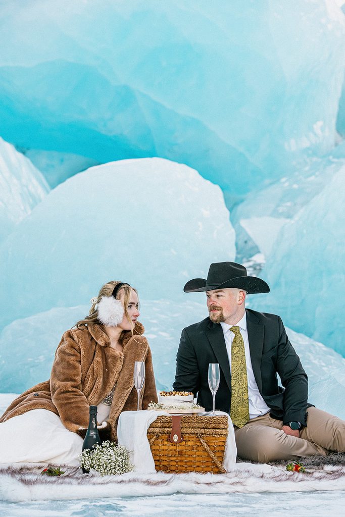 Bride and groom having a picnic with cake on Knik Glacier during their Alaska elopement